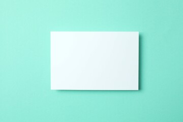 Fototapeta premium Paper card on color background. Empty greeting card for text design