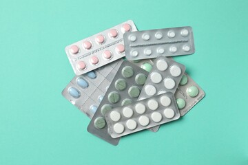 Various blisters with tablets on a colored background