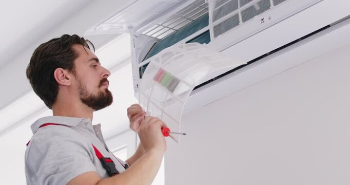 Split system testing and inspection by HVAC inspector, checking power sources, cleaning filters, ensuring proper cooling or heating, temperature fixing, installation by licensed professional man