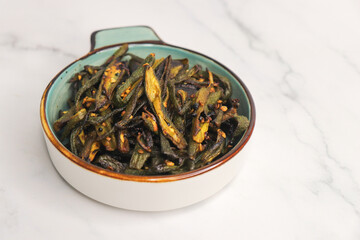 Bhindi Masala, stir-fried okra with Indian spices. Ladyfinger fry. Copy space. Bhendi ki sabzi.