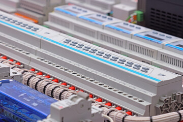 Automation modules controlled via a digital data bus. It is installed in an electric switchboard. Soft focus.