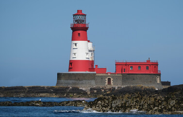 Fototapeta premium Longstone Lighthouse is an active 19th century lighthouse on Longstone Rock in the outer group of the Farne Islands off the Northumberland Coast, England. Completed in 1826.