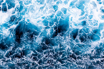 Aerial view of awesome foamy water. Sea surface background. Can be used in covers, packaging, posters, textures, wallpapers, art, and design projects. Classy nature background image.
