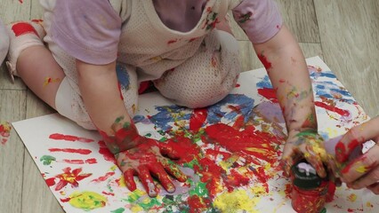 funny kid show their palms the painted paint. creative classes fine arts. laugh. happy children and...