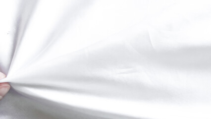 Obraz premium Delicate white tulle veil background with soft folds and elegant texture