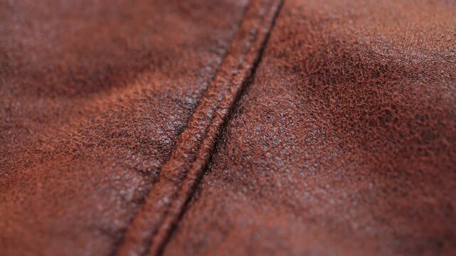 Close up of brown faux leather. Concept of textile y texture. High quality 4k footage