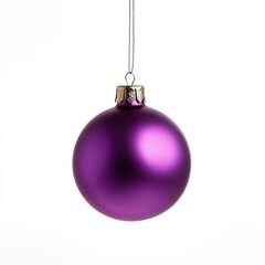 Purple Christmas ornament hangs on a thread, against an isolated white background