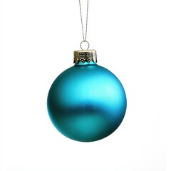 Turquoise Christmas ornament hangs on a thread, against an isolated white background