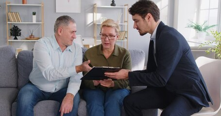 Young real estate agent, licensed professional lawyer, realtor speaking to senior, financial advisor giving consultation to elder, legal advice to senior couple of clients about new flat, buying  - Powered by Adobe