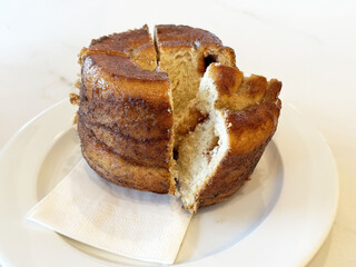 Delicious cinnamon chiffon cake zuckerreinkerl with a slice cut on a white plate