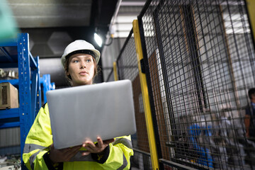 Caucasian engineer or technician woman use notebook computer checking electronic equipment stock