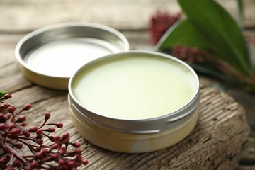 Natural solid perfume and skimmia plant on table, closeup