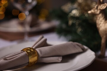 Festive table setting with plate, napkin and decor indoors, closeup