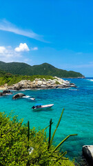 Tropical Coastline with Boat and Vibrant Blue Waters