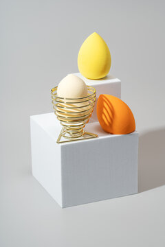 Elegant display of vibrant makeup sponges on geometric stands