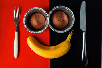 The face of two cupcake muffins and banana