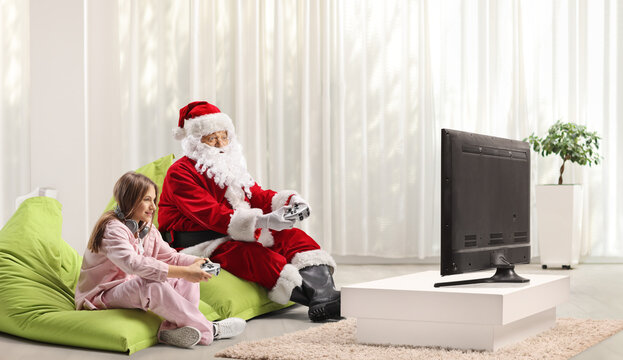 Santa claus playing video games with a teenage girl
