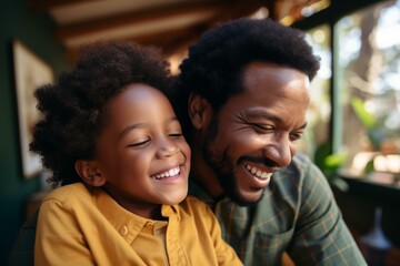 Father and son sharing a happy moment, laughing together in their home, enjoying quality time and creating lasting memories