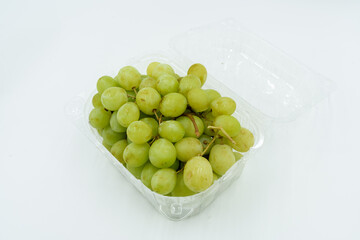 Fresh green grapes in clear plastic container, perfect for snacking