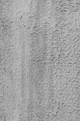 Vertical photo of a grey abandoned wall with stains.