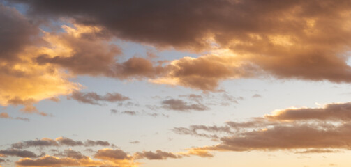 Sunset sky background. Beautiful bright sunset sky with clouds.