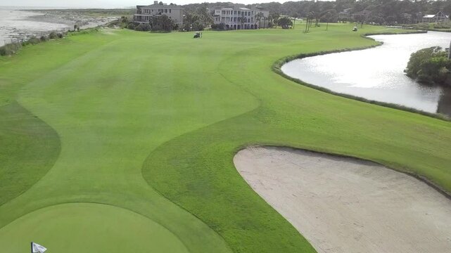 Rising aerial drone shot of oceanfront golf course and homes in South Carolina
