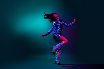 Full size photo of pretty young girl clubbing dancing wear trendy discotheque vintage clothes isolated on dark background