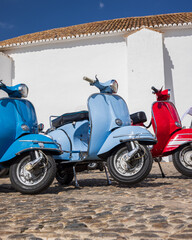 Row of scooters parked on the street