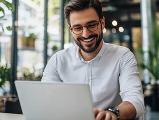 Smiling Businessman Working on Laptop