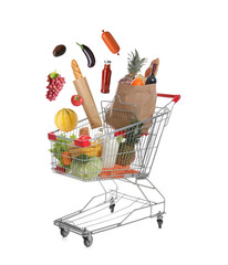 Groceries falling into shopping cart on white background