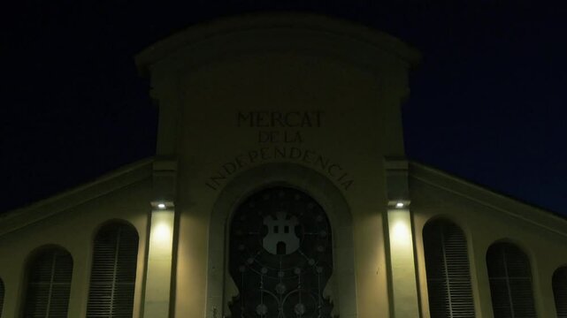 Mercat de la Independ&egrave;ncia old, retro, vintage building exterior fa&ccedil;ade in Terrassa, Catalonia at night
