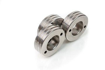 Set of metal washers on white background. Three round thick metal washers. industrial hardware for assembly and fastening.