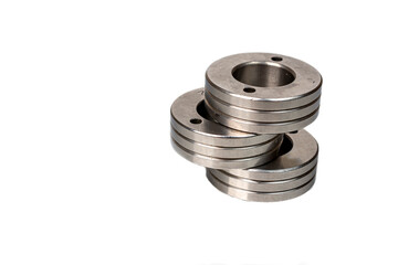 Set of metal washers on white background. Three round thick metal washers. industrial hardware for assembly and fastening.