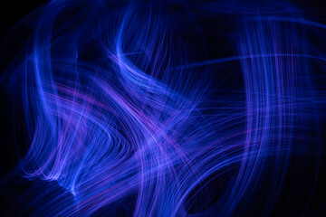 Intertwining lines of light on a black background