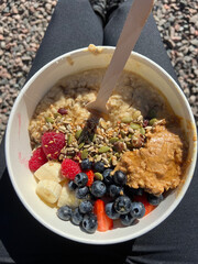 Delicious Breakfast Bowl: Creamy Porridge with Fresh Fruit, Peanut Butter Topping, and Healthy Morning Vibes , Perfect for an English Breakfast or Healthy Start