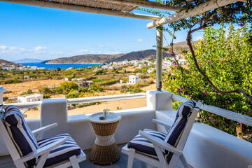 Two chairs and coffee table on terrace of a traditional Greek style apartment in Katapola village, Amorgos island, Cyclades, Greece