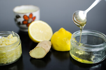 Lemon,  ginger and honey, ingredients to boost immune system, to strengthen immunity on black table