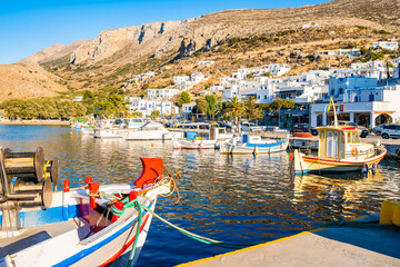Fishing boat and sailing yachts anchoring in  Aigiali port (Ormos Egialis) at sunset, Amorgos...