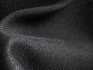Macro photography of dark fabric, highlighting its texture and depth of color, creating an atmosphere of elegance and comfort