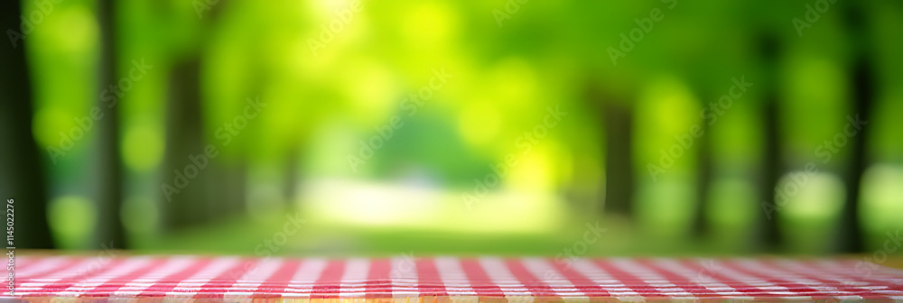 Poster a red checked tablecloth sits atop a wooden surface, subtly blurred by the vibrant green bokeh of a 