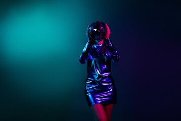 Photo of gorgeous young girl disco ball cover head empty space wear shiny dress neon light dark...