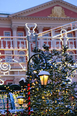 Obraz premium Christmas background. christmas tree in Festive decorations, glowing garlands and street lantern outdoor. winter holidays season