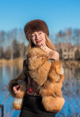 Slavic retro aesthetic. Portrait of a European type Blond head Young woman with natural skin in fur...