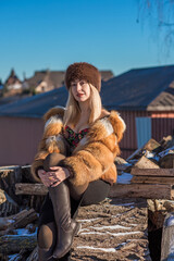 Slavic retro aesthetic. Portrait of a European type Blond head Young woman with natural skin in fur hat.