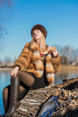 Slavic retro aesthetic. Portrait of a European type Blond head Young woman with natural skin in fur...