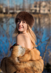 Slavic retro aesthetic. Portrait of a European type Blond head Young woman with natural skin in fur...