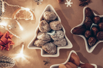 Dried dates fruits in festive plates on a beige background.