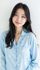 Asian woman in light blue star print pajama set smiling portrait