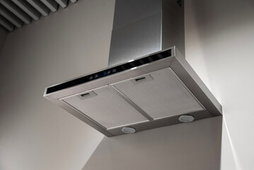 Stainless steel kitchen range hood mounted on a wall