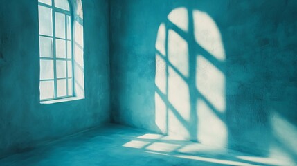 A serene turquoise room with soft shadows casting patterns on the wall.